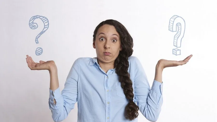 Person thoughtfully comparing two cleaning product bottles to make an informed choice