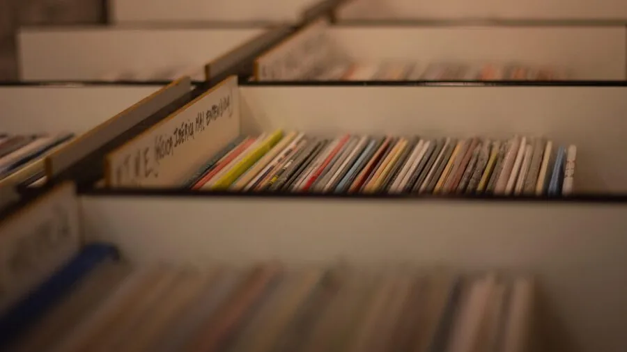 Person transferring vinyl records to digital format using a computer and audio equipment