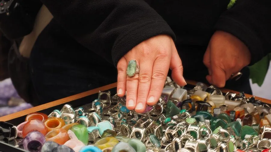 Person trying on a ring to check fit and size during shopping process