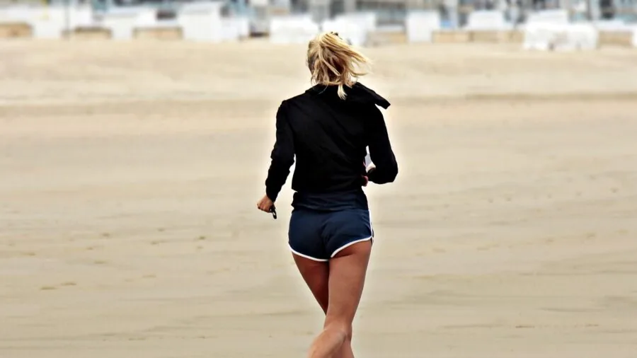 Person trying on different athletic rash guard styles, comparing fit and comfort for water sports