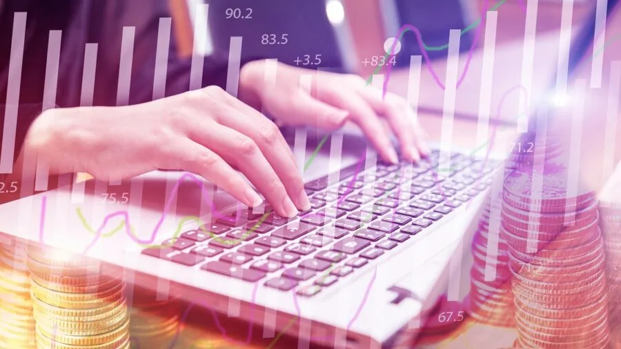 Person typing on laptop keyboard while working at desk, focused on hand position and input comfort