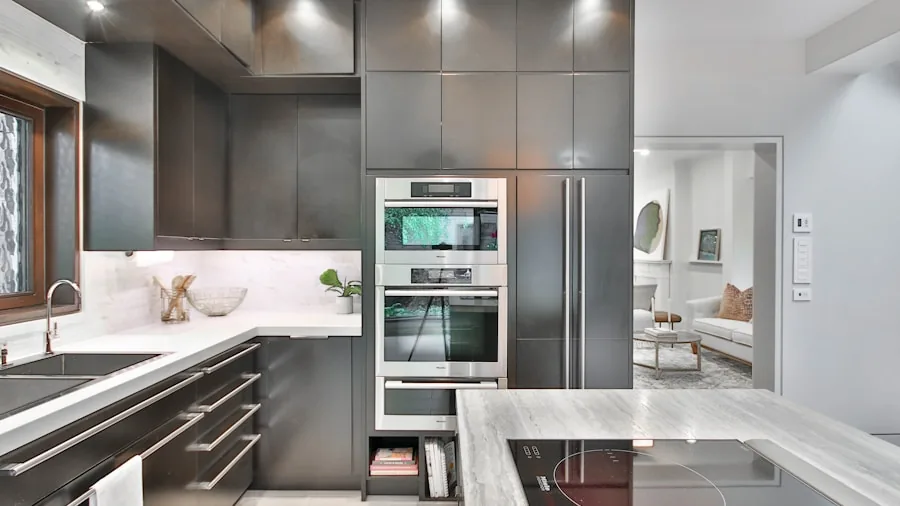 Person using digital touchscreen controls on modern kitchen appliance during meal preparation