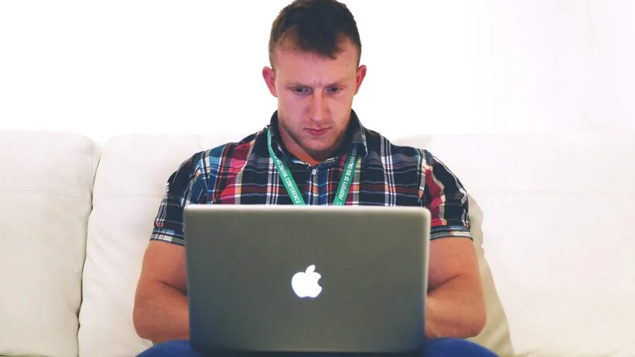 Person using laptop at home desk for remote work and internet connectivity
