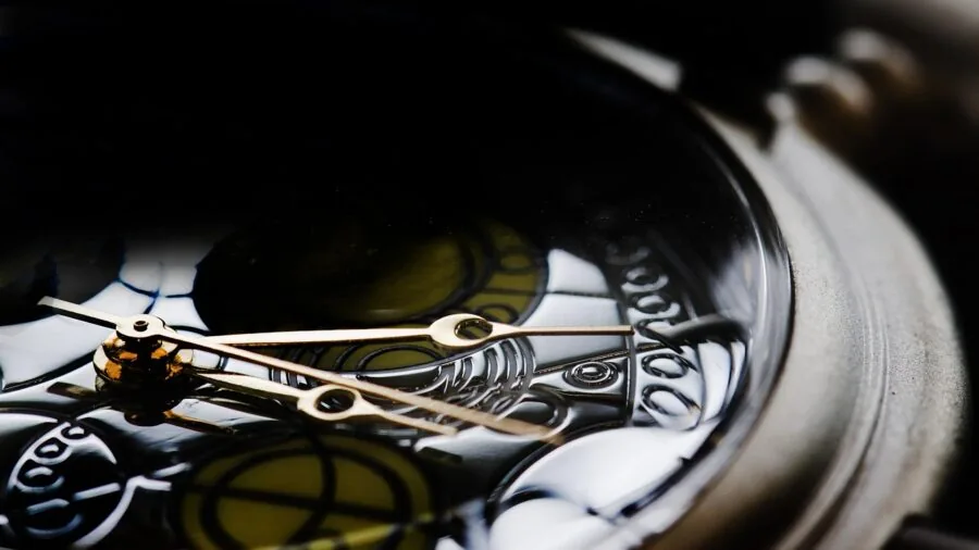 Person using magnifying glass to examine small details with focused concentration and natural lighting