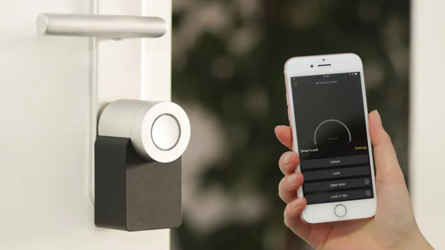 Person using smartphone app to control smart home devices in modern living room