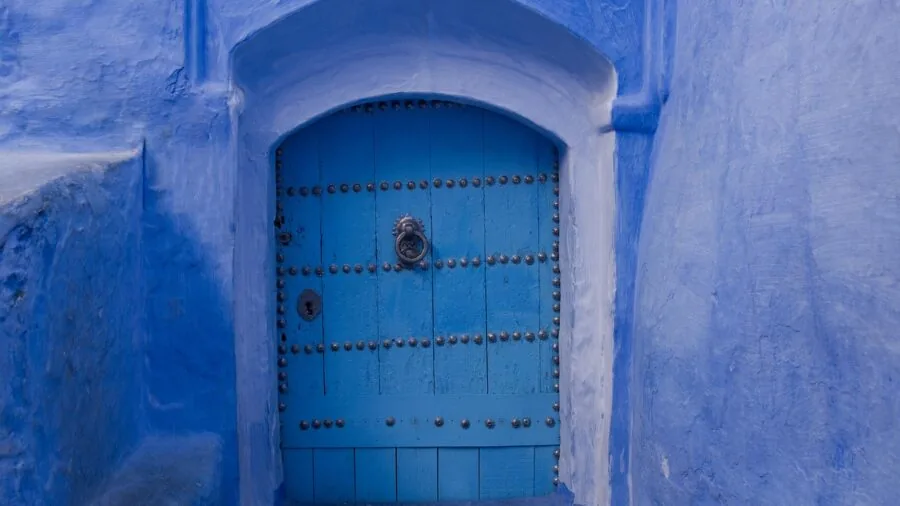 Person using smartphone to unlock their home front door