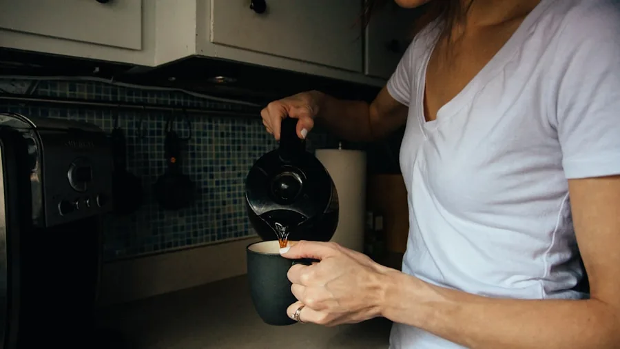 Person waiting for hot water in a bright kitchen during morning routine