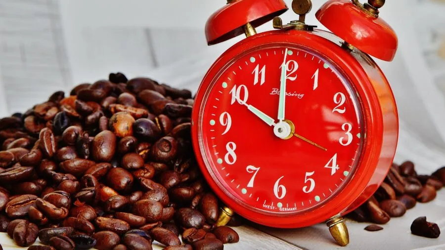 Person waking up to fresh coffee ready in the morning light from bedroom