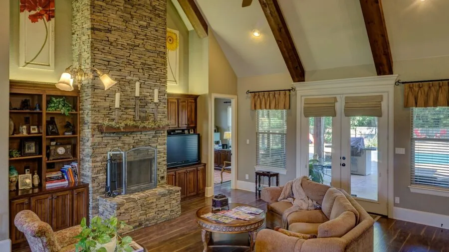 Person walking barefoot on hardwood floor in bright living room with area rug