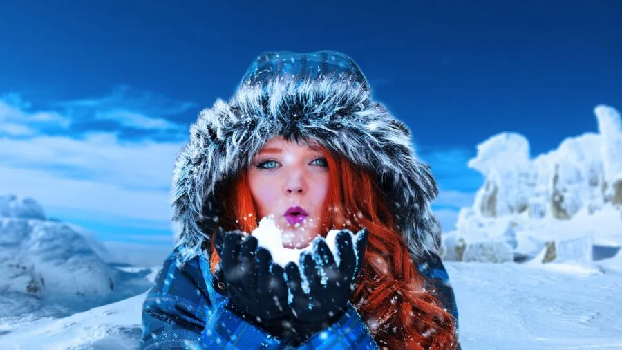 Person warming hands outdoors during cold winter weather, lifestyle scene