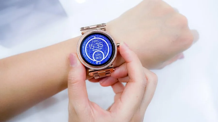 Person wearing a classic minimalist watch on wrist, showcasing refined watch styling in natural light