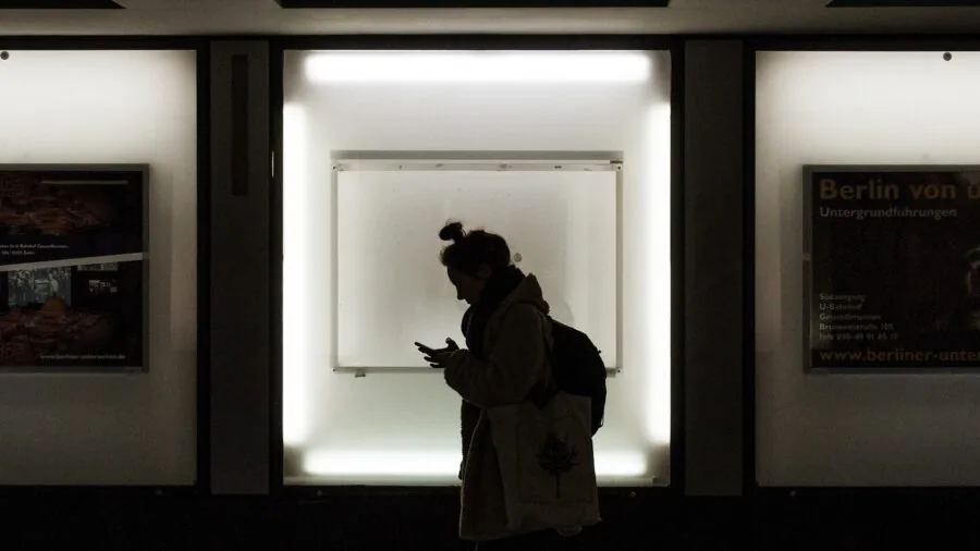 Person wearing a compact backpack while commuting, carrying minimal essentials for work or travel