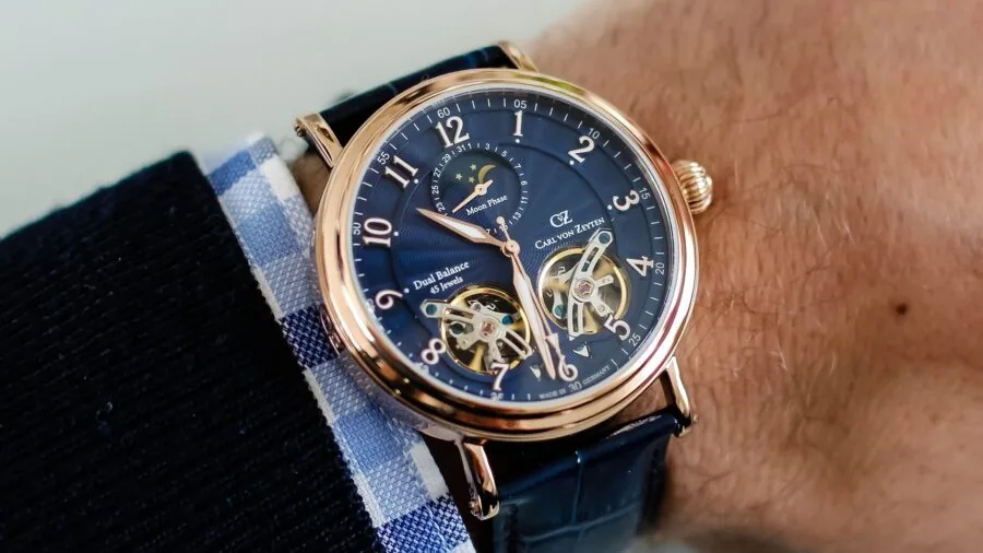 Person wearing a minimalist watch with clean dial design in everyday lifestyle setting