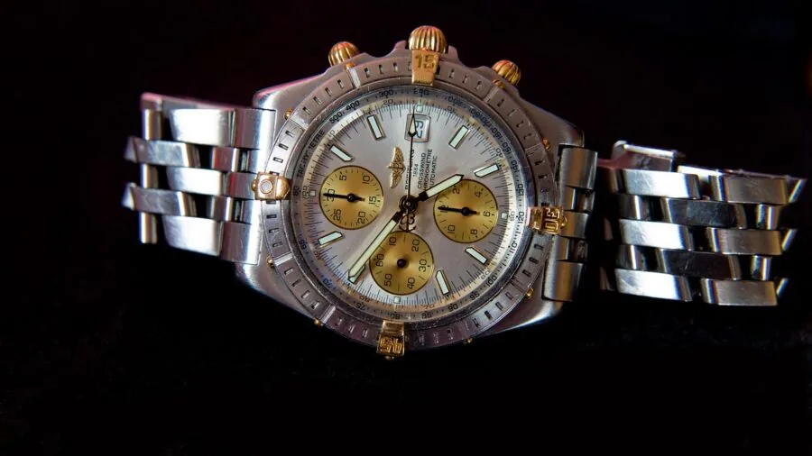 Person wearing a stainless steel watch on their wrist during daily activities