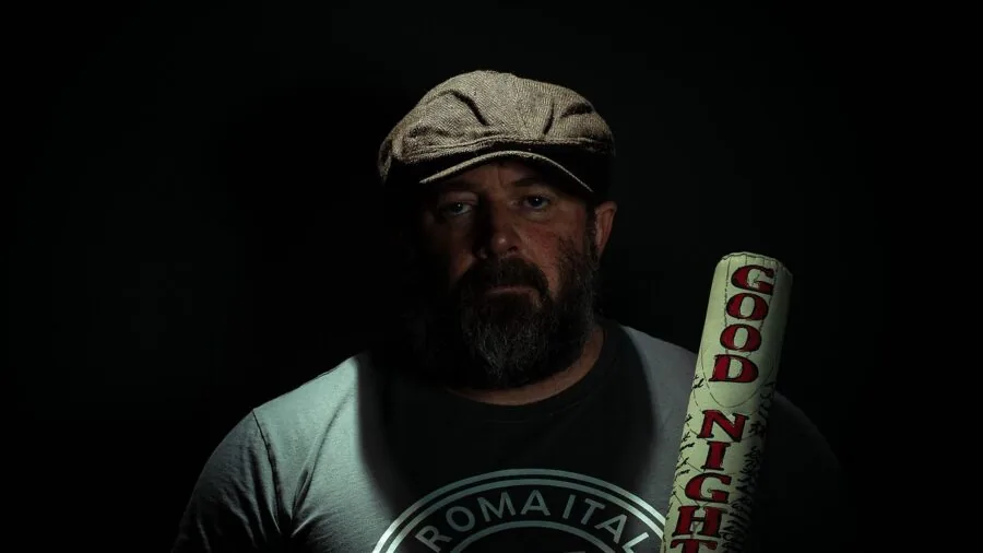 Person wearing a structured baseball cap outdoors in natural lighting