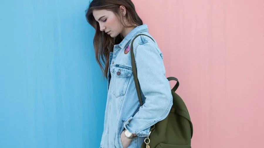 Person wearing a stylish mini backpack as a fashion accessory while out and about