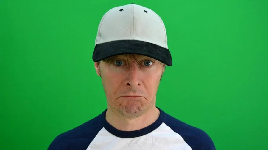 Person wearing baseball cap in outdoor setting, lifestyle scene