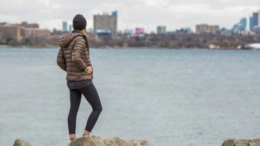 Person wearing beanie outdoors in winter conditions, lifestyle shot showing real-world beanie use