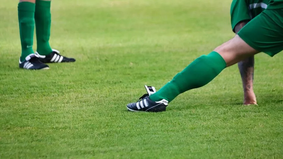 Person wearing calf compression sleeves during active outdoor exercise or training session