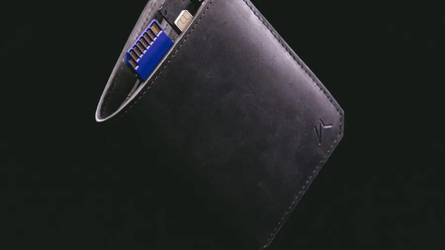 Person wearing casual jeans showing thin wallet in front pocket for minimal bulk