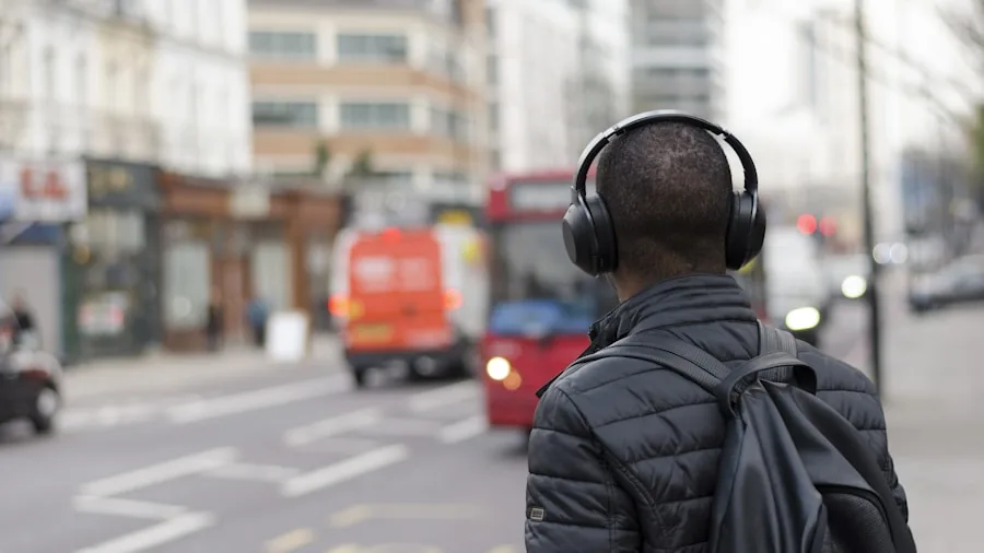 Person wearing earbuds during daily commute, enjoying music in urban environment