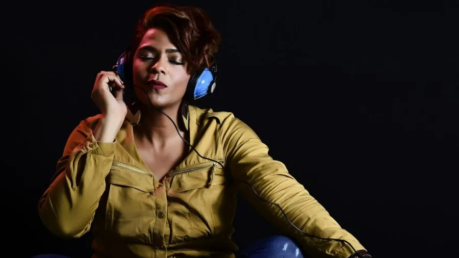 Person wearing headphones in focused listening moment, demonstrating audio quality and comfortable wear during music session