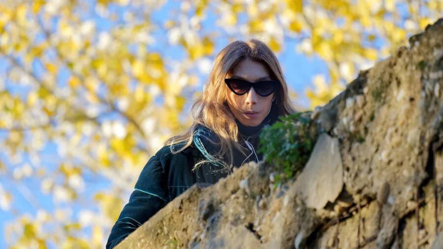 Person wearing protective earmuffs while working outdoors in natural daylight