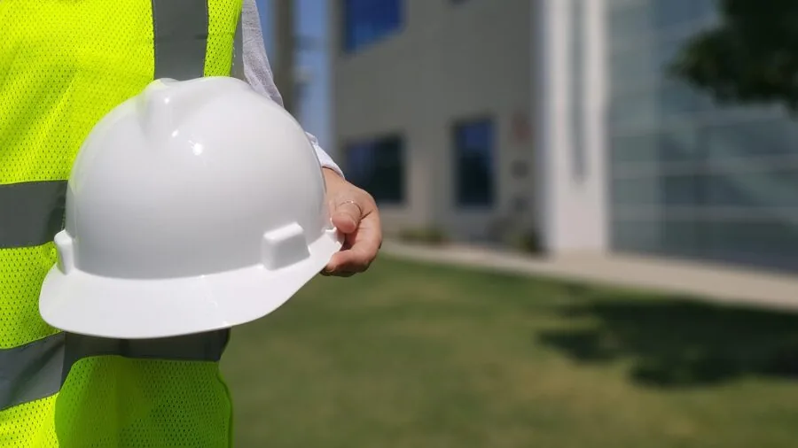 Person wearing safety goggles while working on a project, demonstrating proper eye protection in a real-world setting