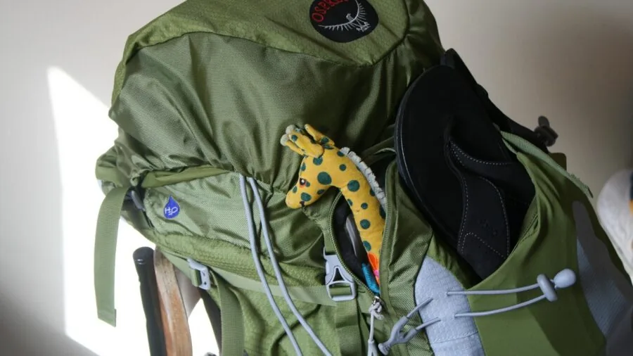 Person wearing secure backpack while navigating urban street, demonstrating anti-theft travel pack features