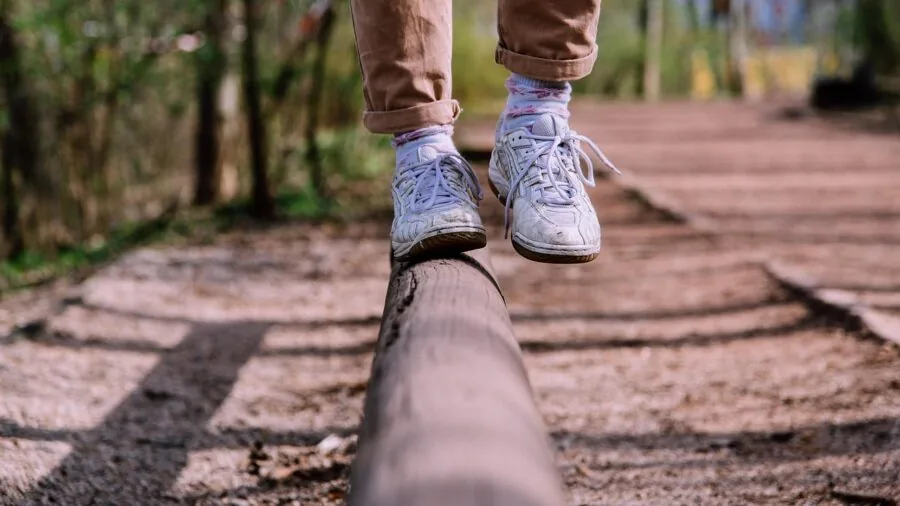 Person wearing smartwatch during outdoor exercise, checking wrist display in natural sunlight