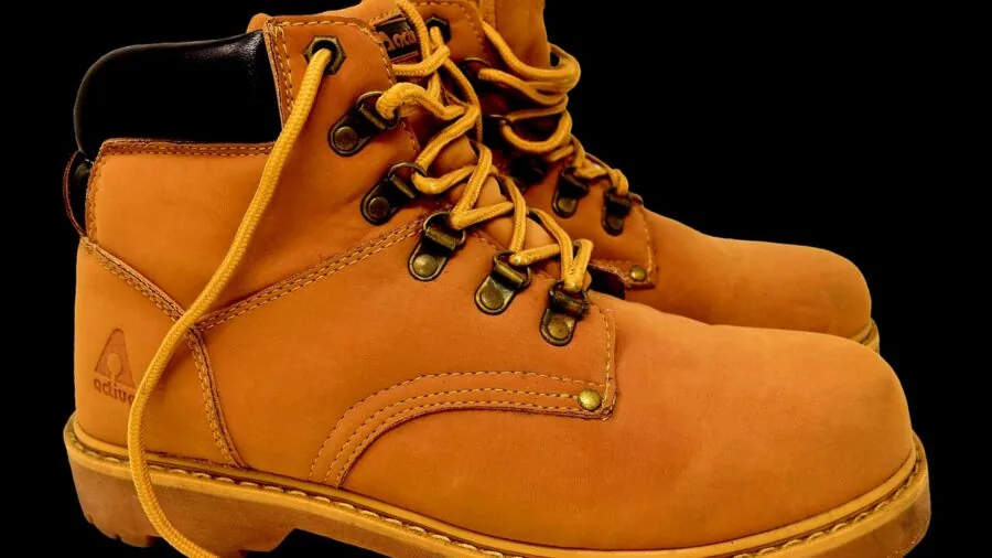 Person wearing well-fitted leather boots, showing comfort and quality craftsmanship in natural lighting