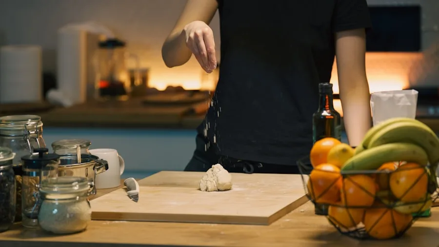Person wiping down kitchen countertop with cleaning cloth during household cleaning routine