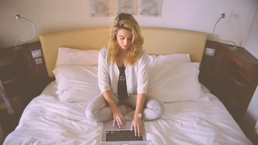 Person working at computer desk during unexpected power loss or blackout situation