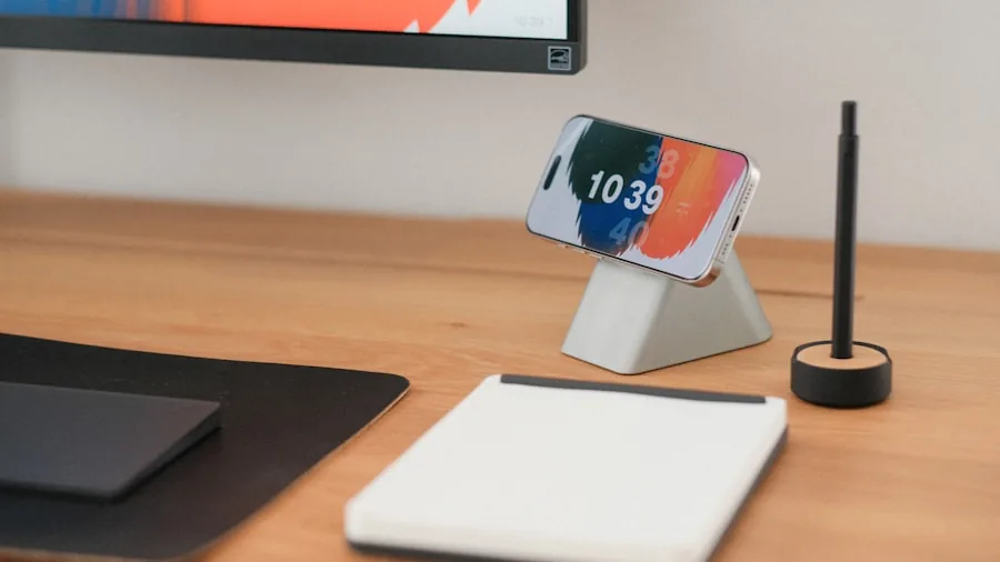 Person working at desk with phone stand, showing stable mobile device placement during work