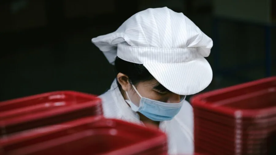 Person working indoors under artificial lighting in industrial setting