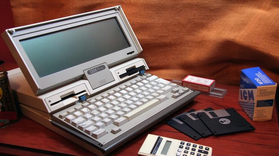 Person working on a flexible laptop in a comfortable, casual setting demonstrating device versatility