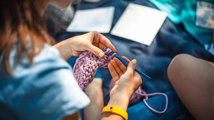 Person working on a small creative craft project at home during leisure time