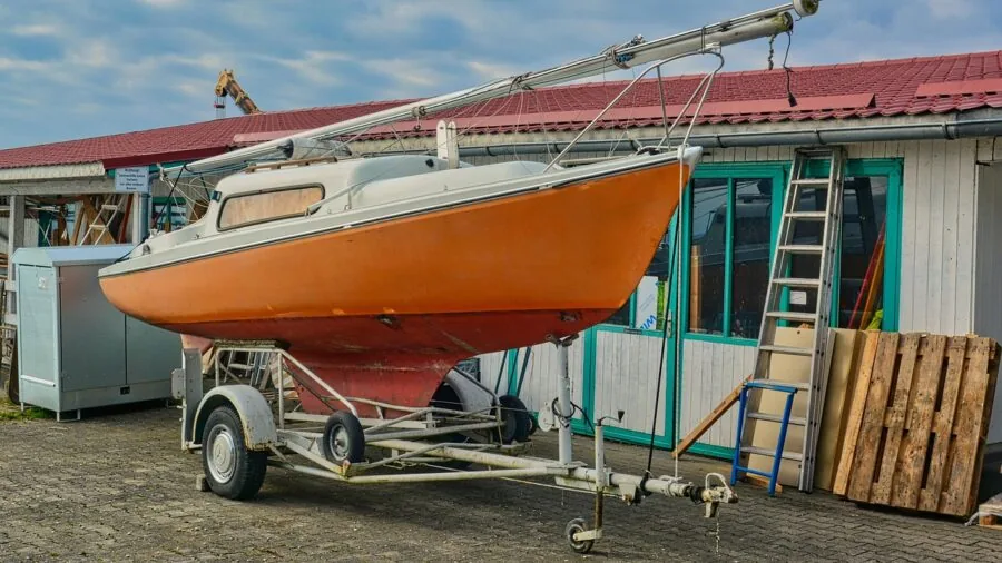Person working on boat electrical wiring and connections in marine engine compartment
