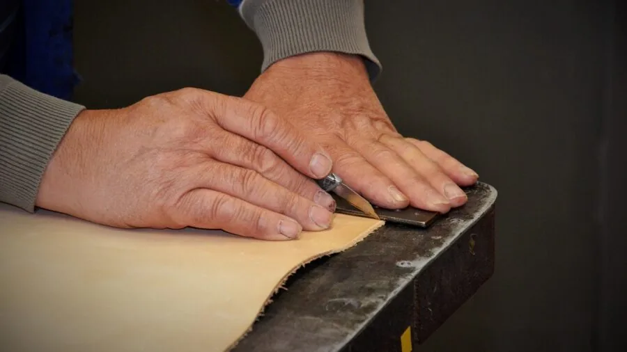 Person working with precision tools in a well-organized workshop, demonstrating quality craftsmanship and durability