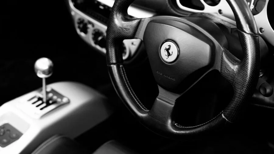 Person's hands carefully installing a steering wheel cover onto a vehicle's steering wheel