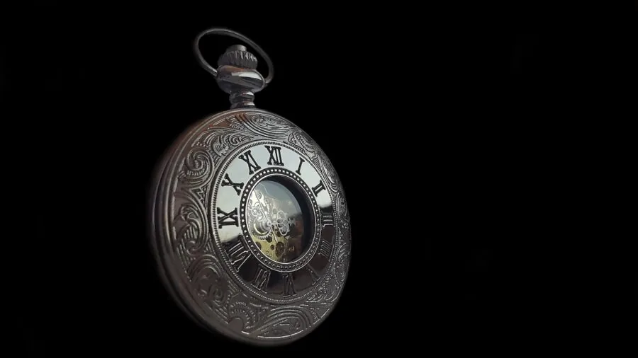 Person's hands carefully turning a focus adjustment dial with concentration