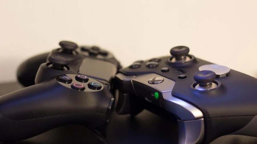 Person's hands gripping a gaming controller during competitive gameplay session