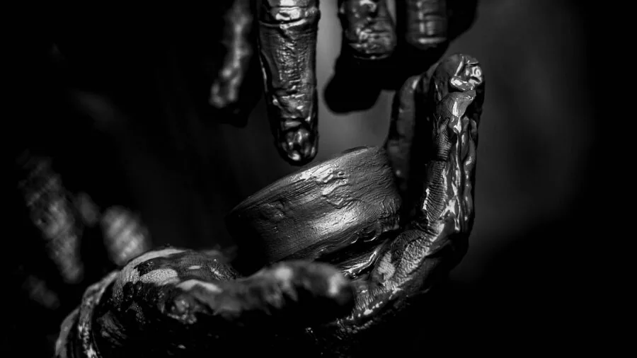 Person's hands working with bolts and fasteners during construction or assembly project