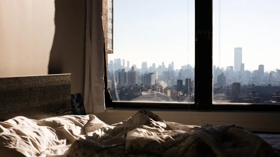 Pet bird resting peacefully in dimly lit bedroom environment during nighttime