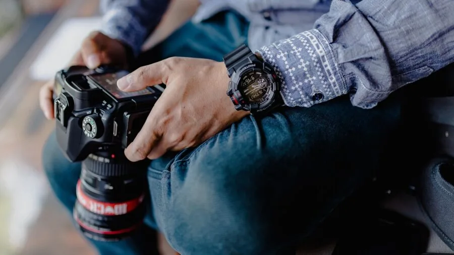 Photographer carrying camera equipment on outdoor adventure, testing durability and load capacity