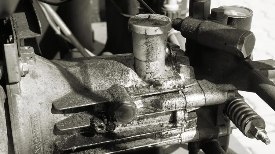 Professional carpenter operating pneumatic tools on construction job site with air compressor