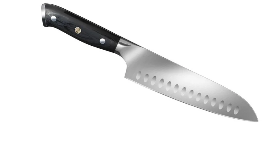 Professional chef inspecting a quality kitchen knife blade in natural light