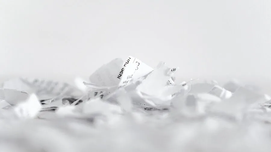 Professional destroying sensitive paperwork in office setting for security and privacy