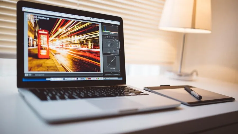Professional editor working on video editing project at computer workstation