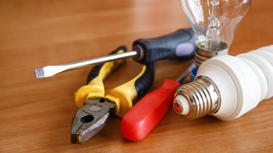 Professional electrician selecting tools and equipment for electrical work project